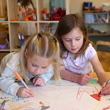 two girls drawing at daycare