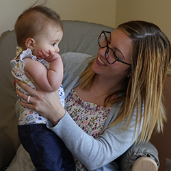 Teacher holding a infant on her lap