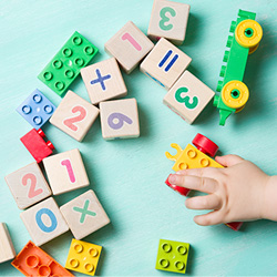Child playing with colorful alphabet blocks