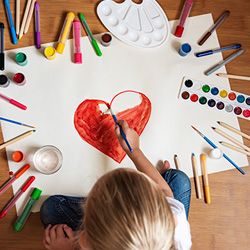 Child painting with bright colors during arts and crafts time